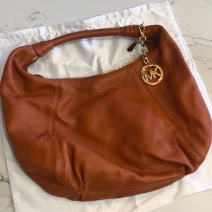Michael Kors dark orange leather purse.